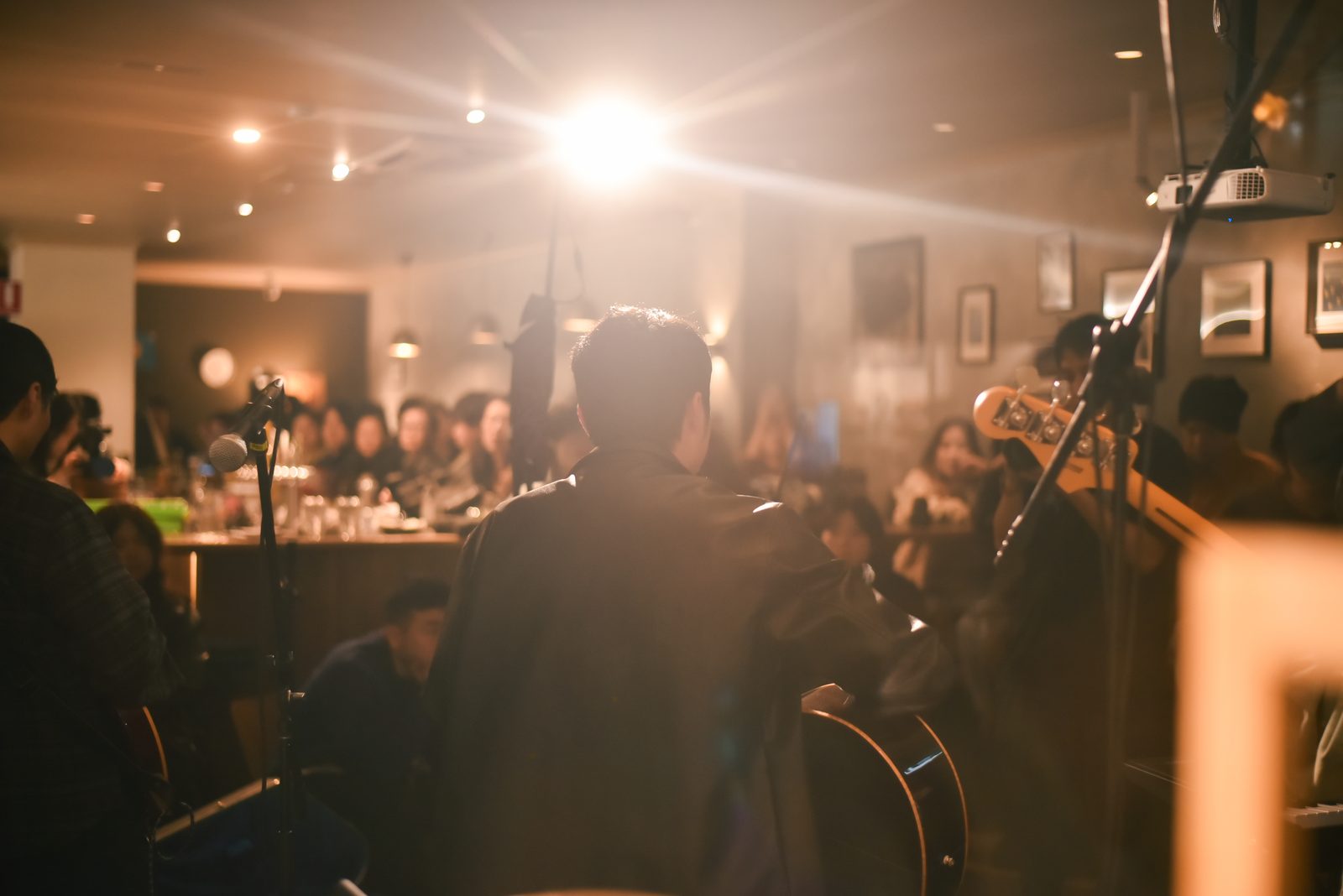 Guitarist performing to a packed room at Acidity